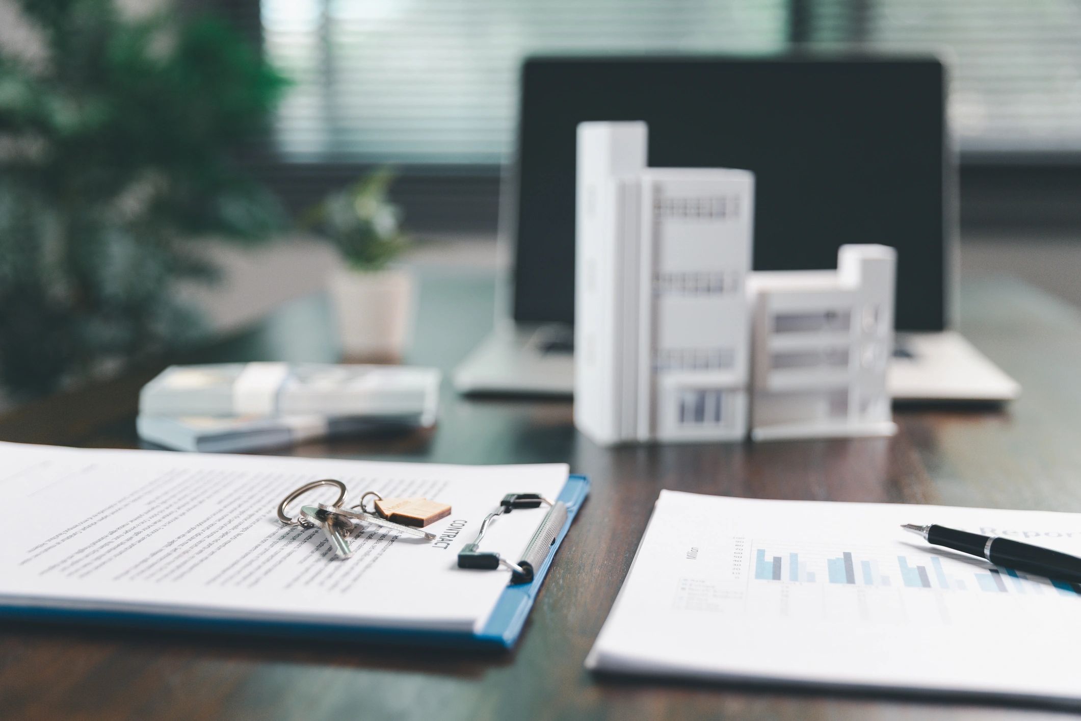 House model and paperwork representing property law and title services